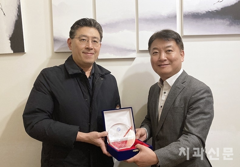 치과신문 편집인인 서울시치과의사회 최성호 공보이사(사진 왼쪽)가 법률칼럼을 1년여 간 집필해준 하태헌 변호사(사진 오른쪽)에게 감사패를 전달하고 있다..