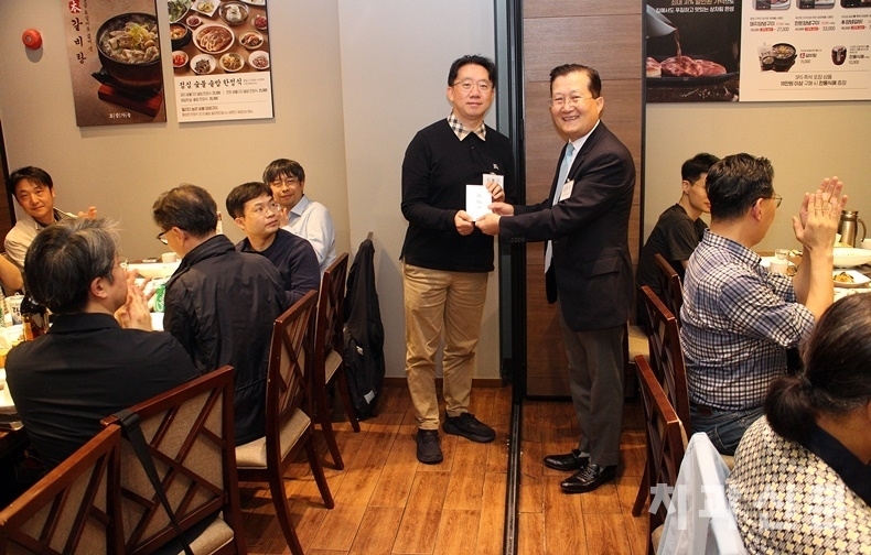 서울시치과의사회 강현구 회장이 도봉구치과의사회 확대이사회에 참석해 민철기 회장(사진 왼쪽)에게 격려금을 전달하고 있다.